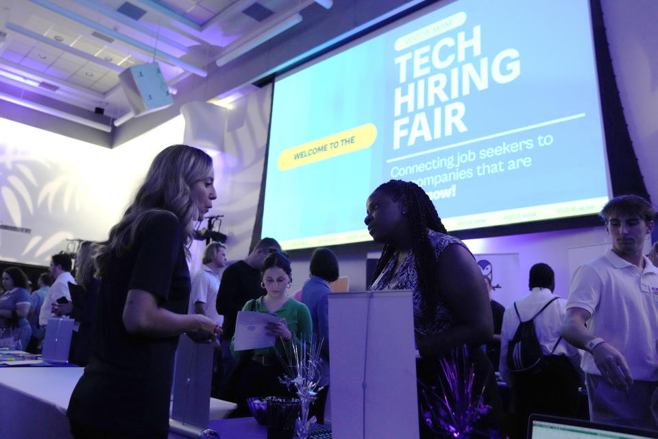 File - Visitors attend the Venture Miami Tech Hiring Fair at the Miami-Dade College, Wolfson campus, Wednesday, April 26, 2023, in Miami. On Friday, the U.S. government issues the May jobs report. The labor market has added jobs at a steady clip in the past year, despite efforts by the Federal Reserve to cool the economy and bring down inflation. (AP Photo/Lynne Sladky, File)