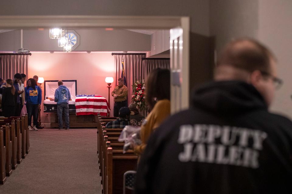 Friends and family pay their respects to Graves County Jail employee, Robert Daniel, during his funeral at Brown Funeral Home in Mayfield, Kentucky on Saturday. Daniel died while supervising seven inmates at the Mayfield Consumer Products facility during last week's tornado. Dec. 18, 2021