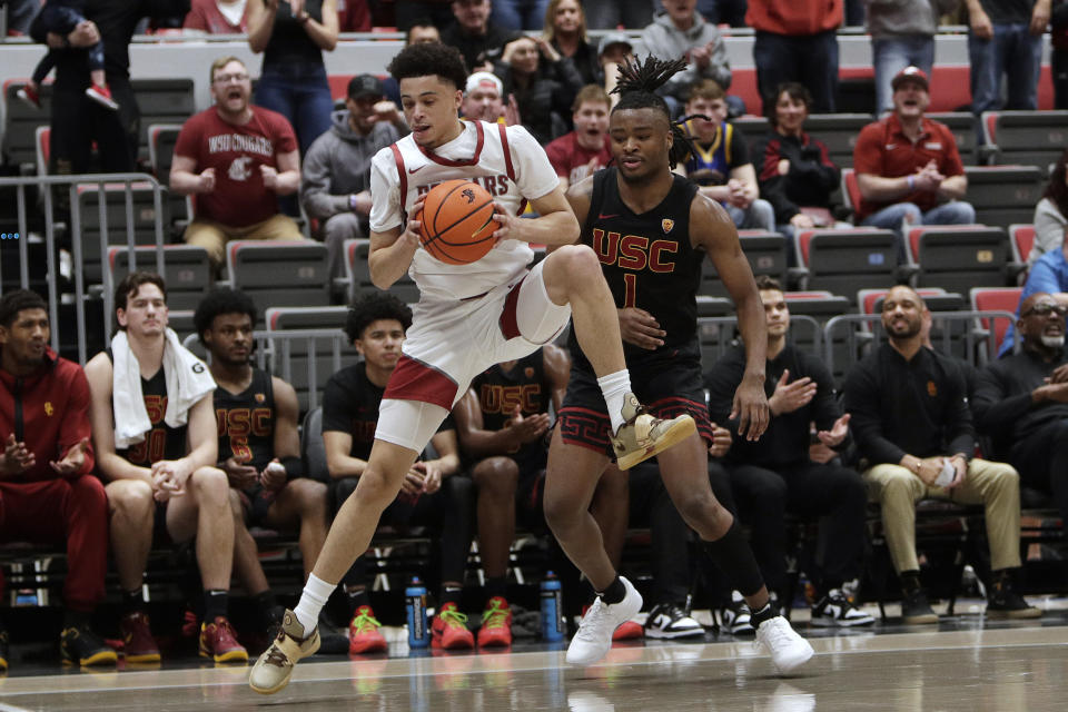 Washington State guard Isaiah Watts, left, intercepts a pass intended for Southern California guard Isaiah Collier (1) during the second half of an NCAA college basketball game Thursday, Feb. 29, 2024, in Pullman, Wash. (AP Photo/Young Kwak)