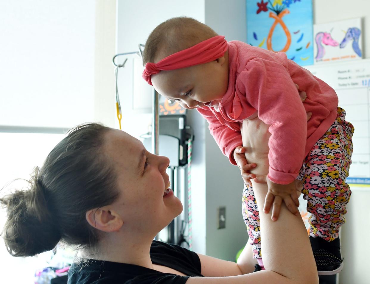 In a file photo, a mother plays with her 11-month-old daughter at UMass Memorial Children's Medical Center.