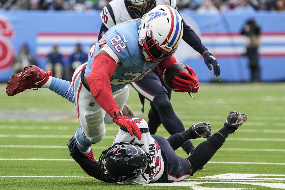 Tennessee Titans running back Derrick Henry (22) is hit by Houston Texans cornerback Steven Nelson (21) during the second half of an NFL football game, Sunday, Dec. 17, 2023, in Nashville, Tenn. (AP Photo/George Walker IV)