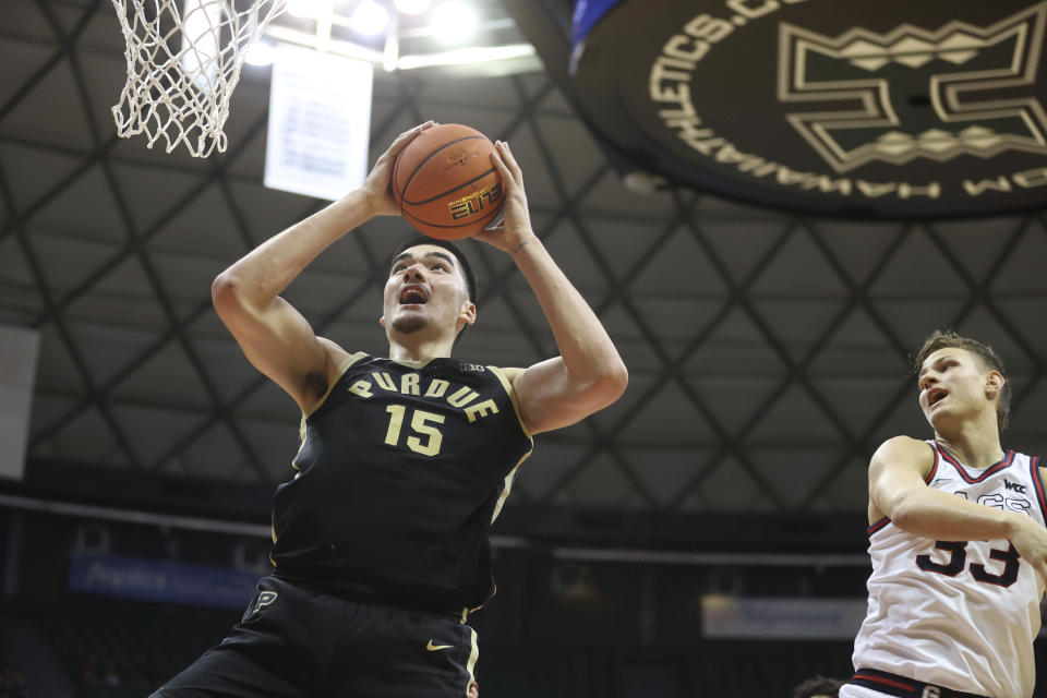 Purdue center Zach Edey (15) grabs a rebound over Gonzaga forward Ben Gregg (33) during the second half of an NCAA college basketball game, Monday, Nov. 20, 2023, in Honolulu. (AP Photo/Marco Garcia)