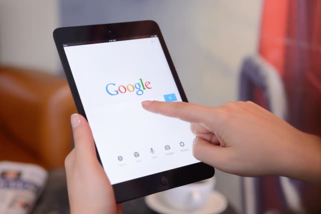 "stanbul, Turkey - January 25, 2013: Womans hands holding a iPad Mini displaying Google Application in a coffee shop. iPad is a touchscreen tablet pc produced by Apple Inc."