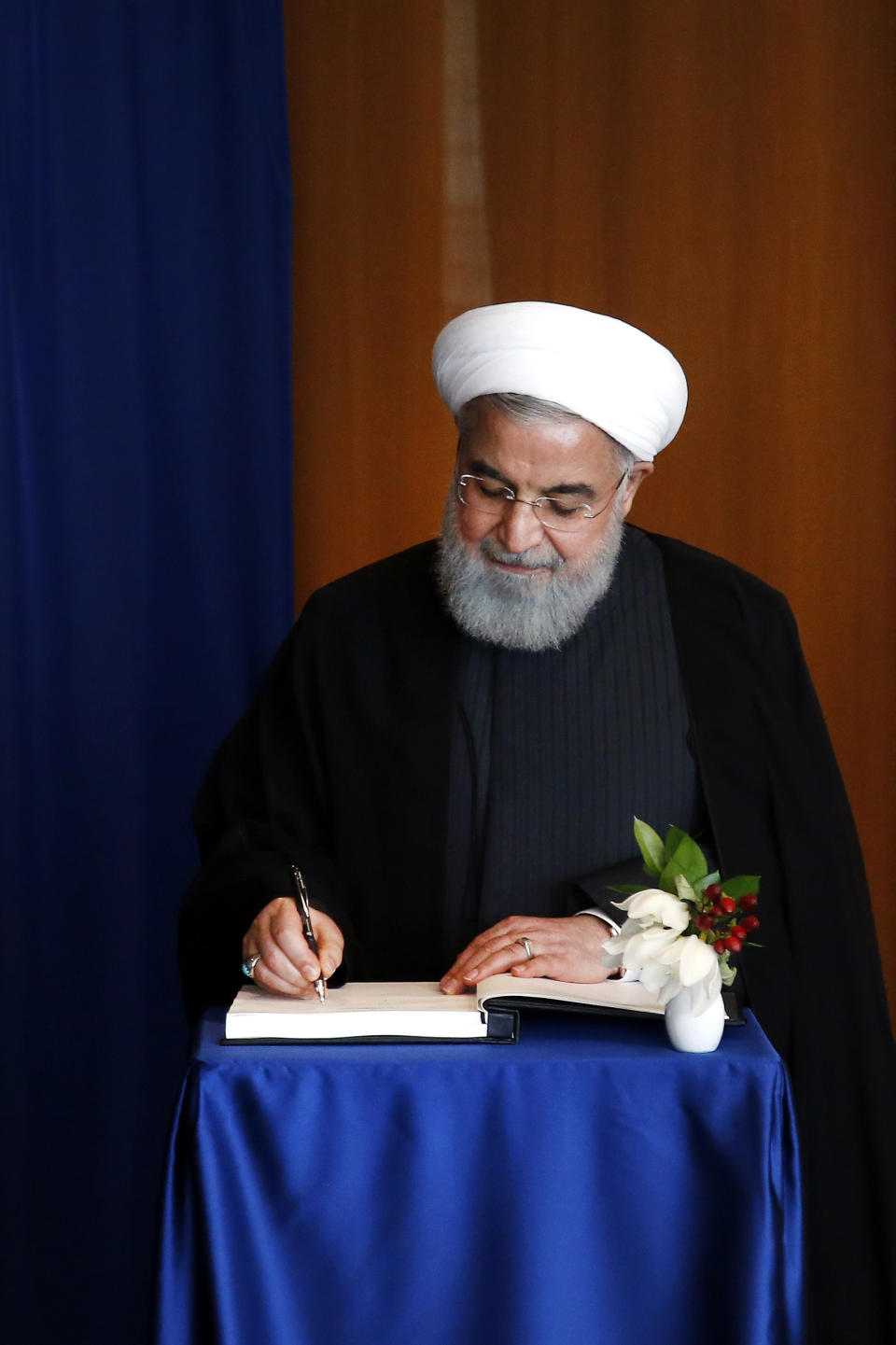 Iranian President Hassan Rouhani signs the guest book as he meets with United Nations Secretary General Antonio Guterres on the sidelines of the 73rd session of the United Nations General Assembly, at U.N. headquarters, Wednesday, Sept. 26, 2018. (AP Photo/Jason DeCrow)