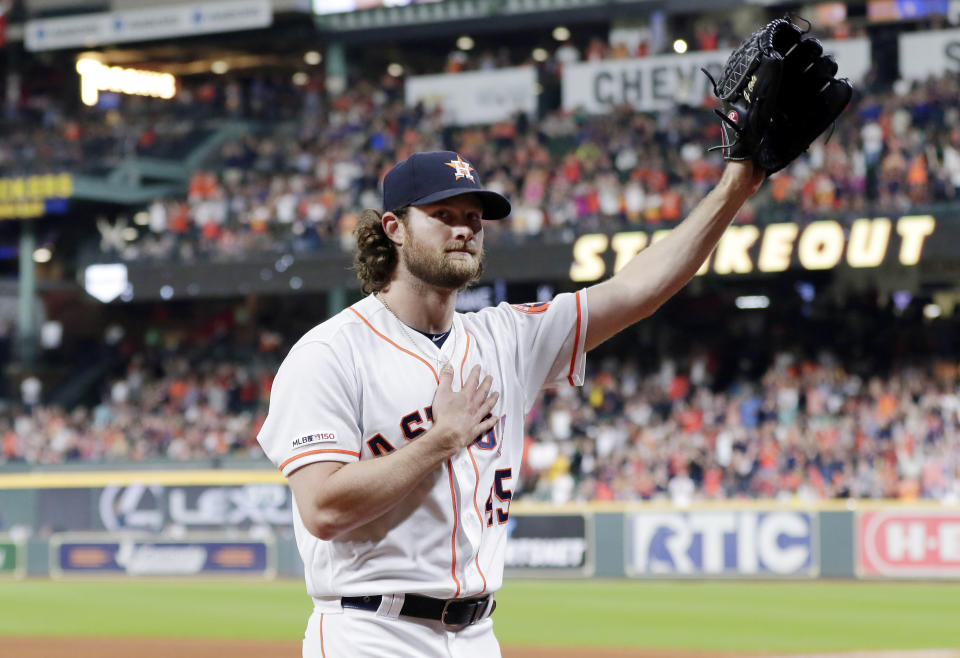 Houston Astros starting pitcher Gerrit Cole waves to the crowd as he leaves the mound after striking out Texas Rangers designated hitter Shin-Soo Choo for his 300th season strikeout during the sixth inning of a baseball game Wednesday, Sept. 18, 2019, in Houston. (AP Photo/Michael Wyke)