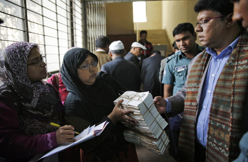 Bangladeshi election officials check ballot papers and other election materials at a distribution center a day before general elections in Dhaka, Bangladesh, Saturday, Jan. 4, 2014. The run-up to Sunday's general election in Bangladesh has been marked by bloody street clashes and caustic political vendettas, and the vote threatens to plunge this South Asian country even deeper into crisis. (AP Photo/Rajesh Kumar Singh)