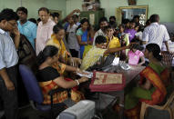 In this Wednesday, May 16, 2012, file photo, Indians crowd a room as they wait to enroll for Aadhar, India's unique identification project in Kolkata, India. India has been embroiled in protests since December, when Parliament passed a bill amending the country's citizenship law. (AP Photo/Bikas Das, File)