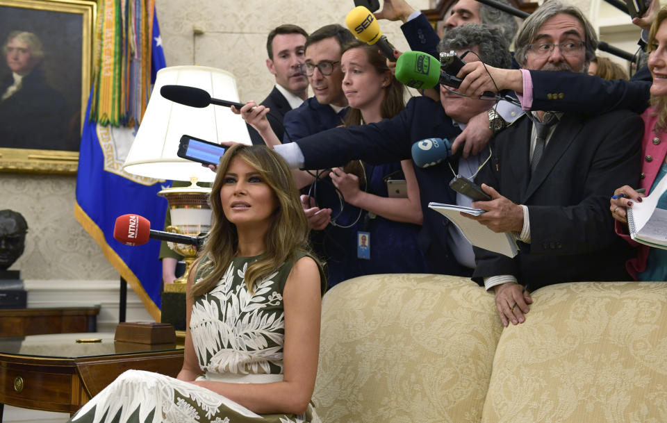 Melania was pictured sitting on a couch alone surrounded by photographers. Photo: AAPting