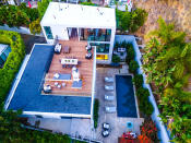 <p>The home sits on about a third of an acre in the Hollywood Hills. Aerial photos like this one were taken by a drone. (Photo: <a href="http://bit.ly/1UCMKf2" rel="nofollow noopener" target="_blank" data-ylk="slk:Sotheby’s International Realty via Catherine Marcus;elm:context_link;itc:0;sec:content-canvas" class="link ">Sotheby’s International Realty via Catherine Marcus</a>, shot by Michael Izquierdo, Beverly Hills Aerial) <br></p>