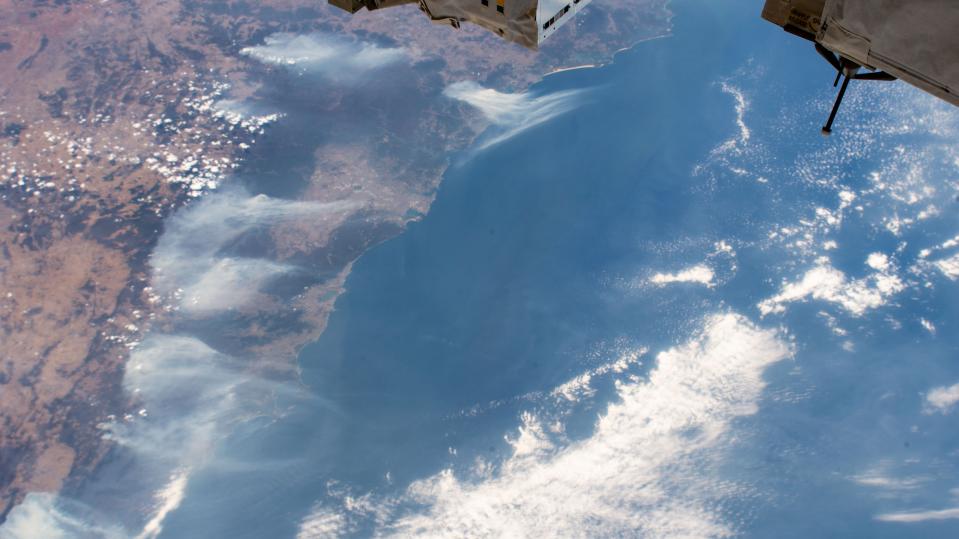 This image taken from the International Space Station on Friday, Jan. 3, 2020 shows wildfires surrounding Sydney Australia as the ISS orbited 269 miles above the Tasman Sea. Australia's prime minister called up about 3,000 reservists on Saturday as the threat of wildfires escalated in at least three states, while strong winds and high temperatures were forecast to bring flames to populated areas including the suburbs of Sydney. (NASA via AP)