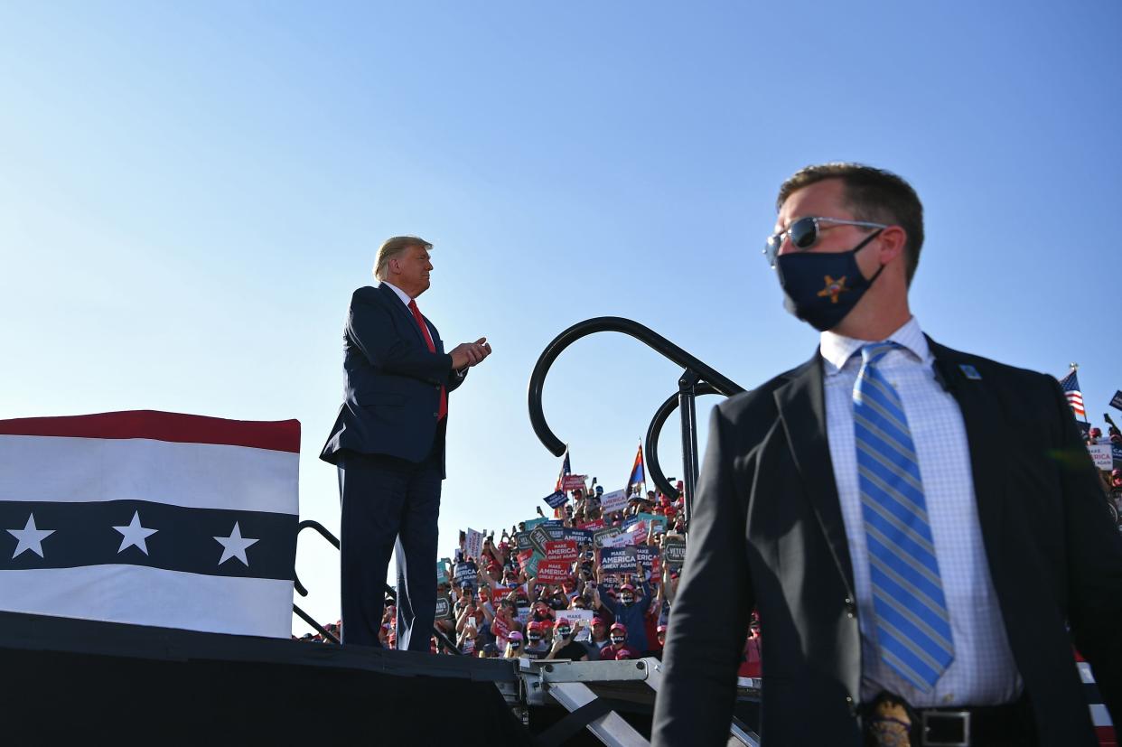 President Trump barnstormed through Arizona on Monday, here listening to Senator Martha McSally speak about her race in Prescott. (AFP via Getty Images)