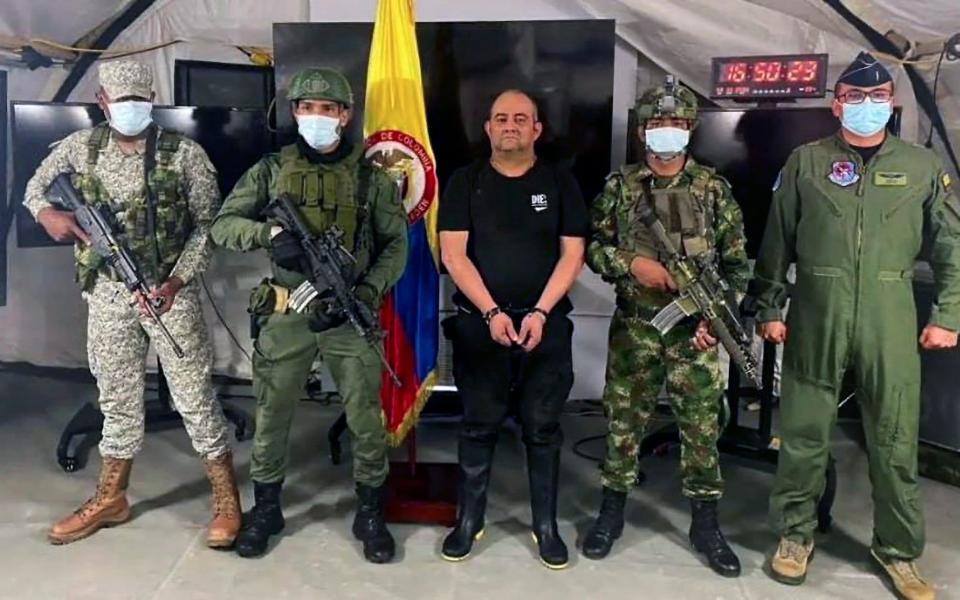 Members of the Colombian Army escorting 50-year-old Otoniel after his capture in Bogota - AFP