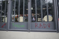 Restaurant employees put chairs and tables against a store front security gate to protect themselves from protestors during a march for abortion rights, in Mexico City, Saturday Sept. 28, 2019. Mexican women on Saturday marched on Saturday highlighting increased efforts across Latin America to lift some of the world's most restrictive abortion laws. (AP Photo/Anthony Vazquez)