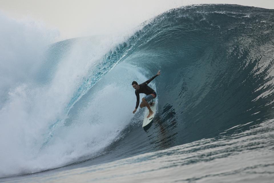 A surfer rides a wave in Teahupo'o, Tahiti, French Polynesia, Saturday, Jan. 13, 2024. The world-famous surf spot is set to host the 2024 Paris Olympics surfing competition. (AP Photo/Daniel Cole)