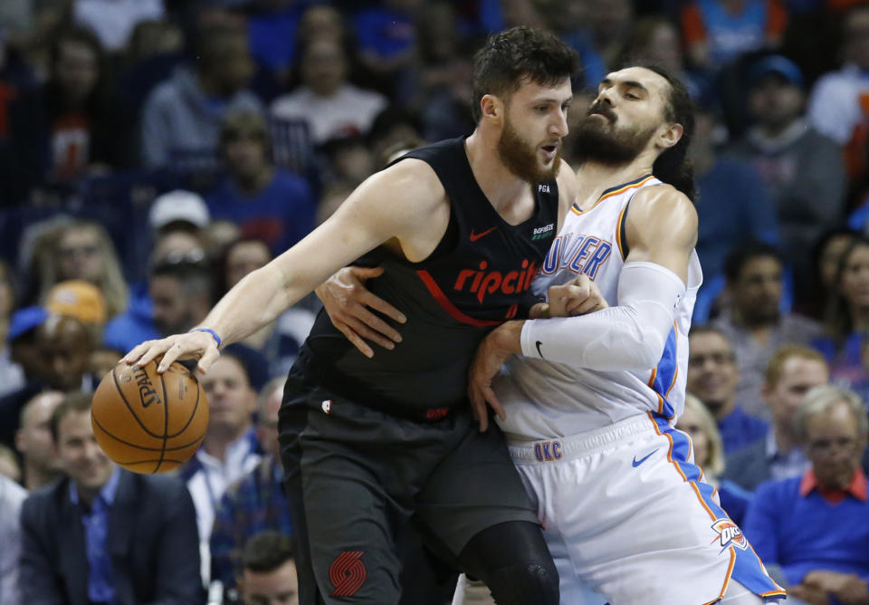 Portland Trail Blazers center Jusuf Nurkic, left, drives around Oklahoma City Thunder center Steven Adams, right, in the first half of an NBA basketball game in Oklahoma City, Monday, Feb. 11, 2019. (AP Photo/Sue Ogrocki)