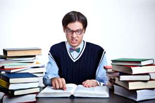 Nerd with piles of books. . Photo HANNA WITTE/dpa/AFP