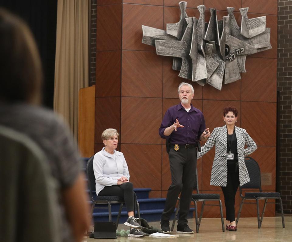 Gary Rhines, director of security for the Shaw JCC, addresses an exercise class while Executive Director Stephanie York listens.