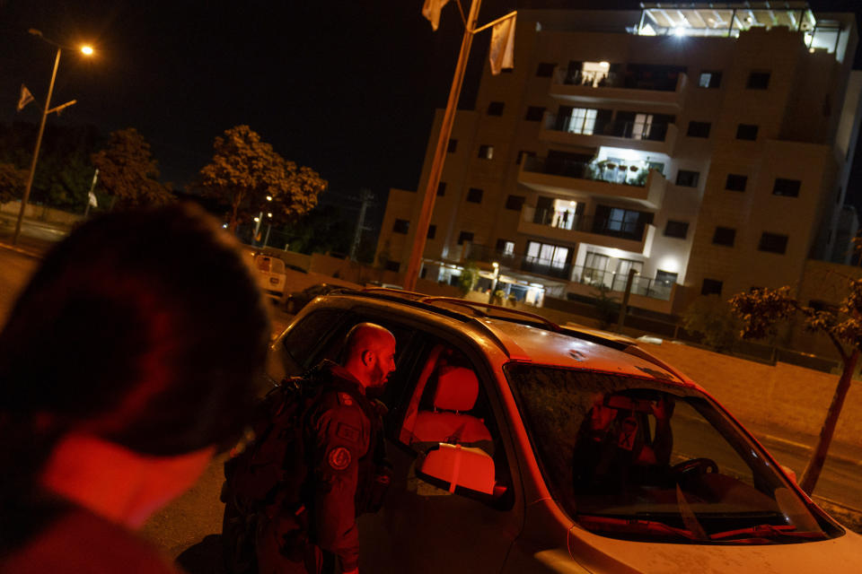 Police stop a car while patrolling a neighborhood in the mixed Arab-Jewish town of Lod, central Israel, Friday, May 28, 2021. Israeli security forces guard the streets of Lod, weeks after rioters torched patrol cars, synagogues and homes. Attackers who killed an Arab and a Jewish resident are still at large. And a mayor whom some blame for setting the stage for some of the worst domestic unrest in Israeli history remains in office. (AP Photo/David Goldman)