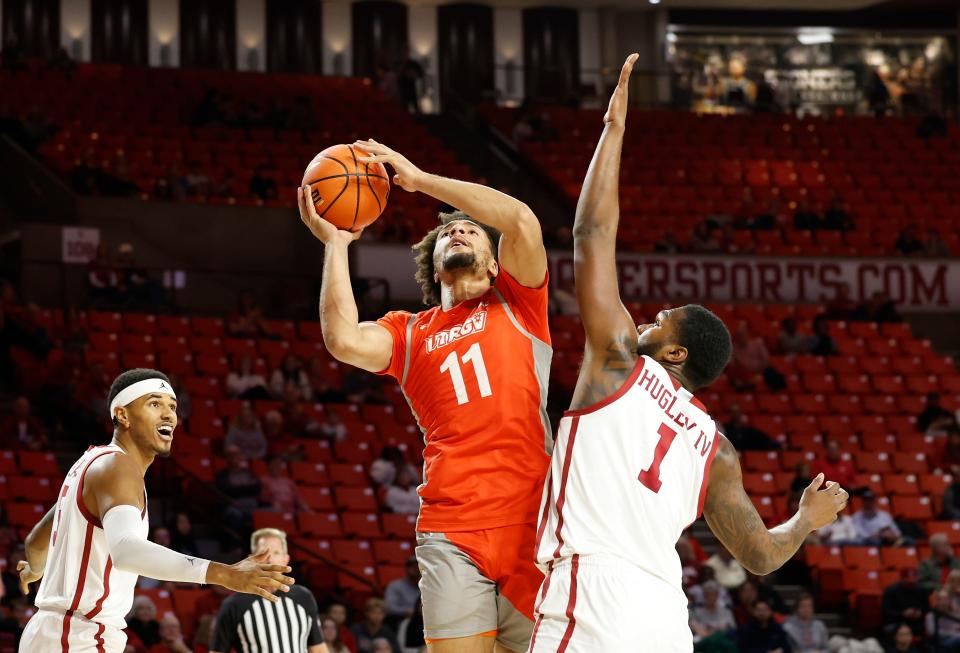 UT Rio Grande Valley forward Ahren Freeman (11) shoots while Oklahoma forward John Hugley IV (1) defends during a November game.