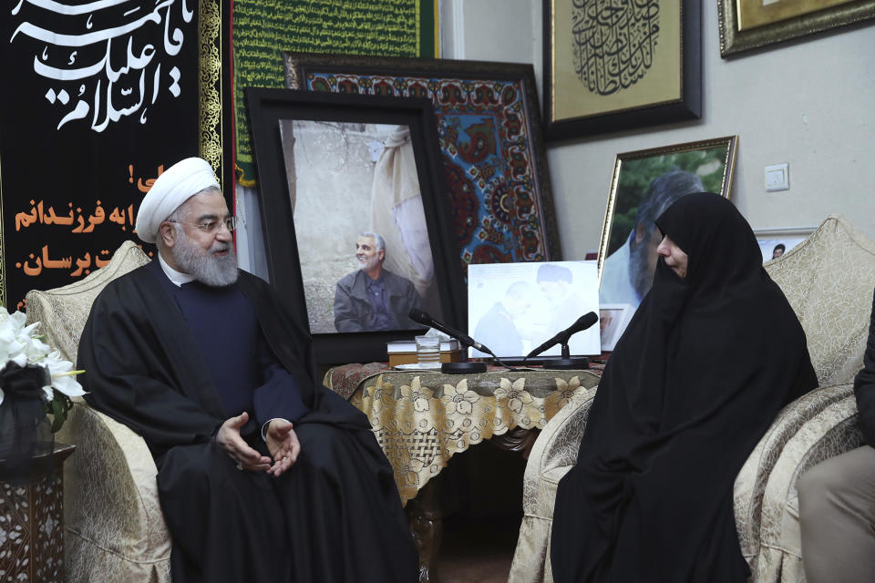 In this photo released by the official website of the office of the Iranian Presidency, President Hassan Rouhani, left, meets family of Iranian Revolutionary Guard Gen. Qassem Soleimani, who was killed in the U.S. airstrike in Iraq, at his home in Tehran, Iran, Saturday, Jan. 4, 2020. (Iranian Presidency Office via AP)