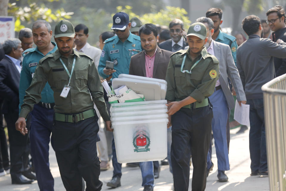 Security officers carry ballot boxes for distribution in Dhaka, Bangladesh,Saturday, Jan. 6, 2024. An apparent arson fire on a train in Bangladesh’s capital killed four people late Friday and added to the country’s extreme tension ahead of Sunday’s parliamentary elections that the opposition is seeking to boycott and disrupt with a general strike. (AP Photo/Mahmud Hossain Opu)