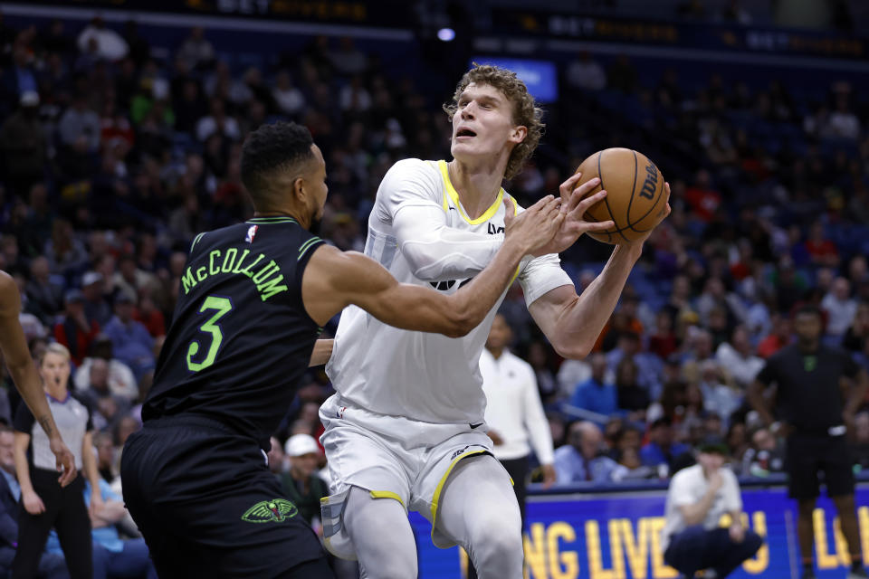 New Orleans Pelicans guard CJ McCollum (3) blocks the attempted shot of Utah Jazz forward Lauri Markkanen (23) during the first half of an NBA basketball game in New Orleans, Tuesday, Jan. 23, 2024. (AP Photo/Tyler Kaufman)