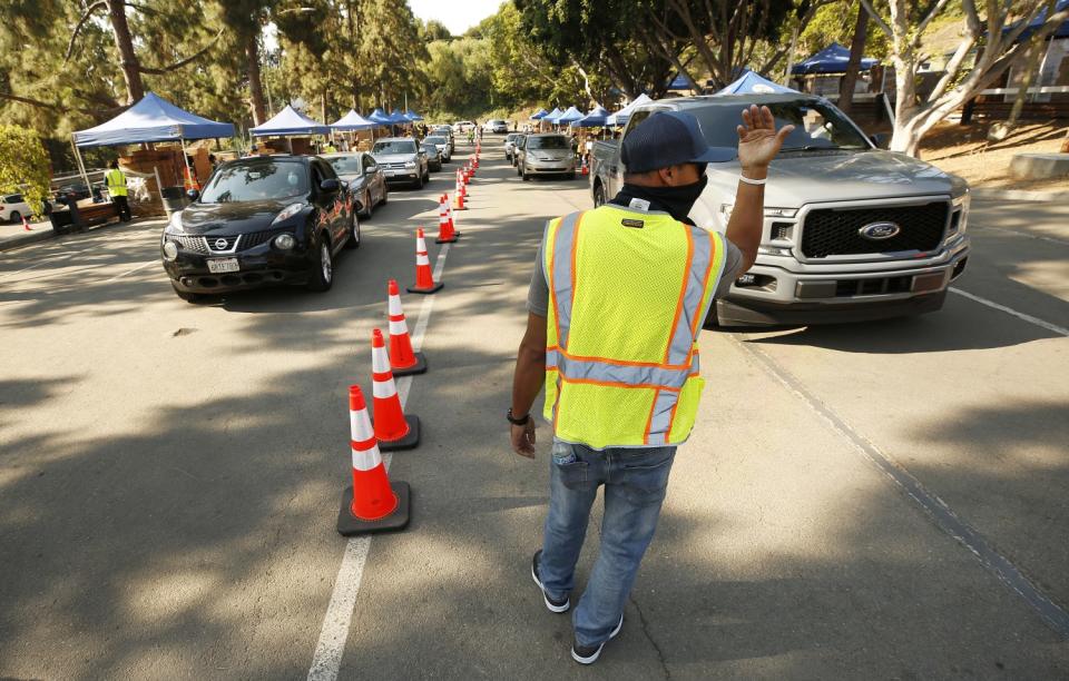 Christopher Escoto, who works for the L.A. County Department of Public Works, directs traffic at the Hollywood Bowl.