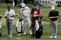 In this Thursday, June 25, photo, Denny McCarthy, left, Matt Wallace, center left, Bud Cauley, right, and Cauley's caddie Matt Hauser stand at the third tee box during the first round of the Travelers Championship golf tournament at TPC River Highlands in Cromwell, Conn. McCarthy told Golfchannel.com that he withdrew from the tournament after feeling sick Thursday night and testing positive for the coronavirus on Friday. Cauley, who played with McCarthy on Thursday, also withdrew before Friday's second round. McCarthy became the third PGA Tour player to test positive for the virus since its restart and the second this week, joining Cameron Champ who withdrew on Tuesday. Nick Watney withdrew just before the second round of last week's RBC Heritage Championship. (AP Photo/Frank Franklin II)