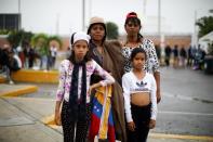 The Wider Image: Venezuelan mothers, children in tow, rush to migrate