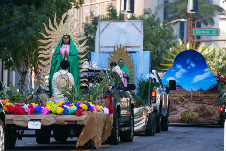 Floats depicting scenes of Our Lady of Guadalupe and St. Juan Diego travel down Monroe Street during a procession in downtown Phoenix on Dec. 2, 2023, to celebrate the feast day of Our Lady of Guadalupe. The feast day is on Dec. 12.