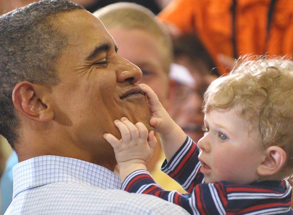 President Barack Obama holds 7-month-old Matthew Ian Clark, from Bozman, Montana, following a town hall meeting on health insurance August 14, 2009, in a hangar at Gallatin Field Airport in Belgrade, Montana.