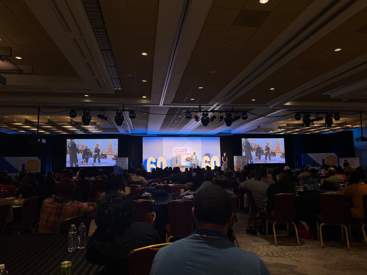 Attendees watch keynote speaker Jason Wilson during Friday's session of the Summit on Poverty.