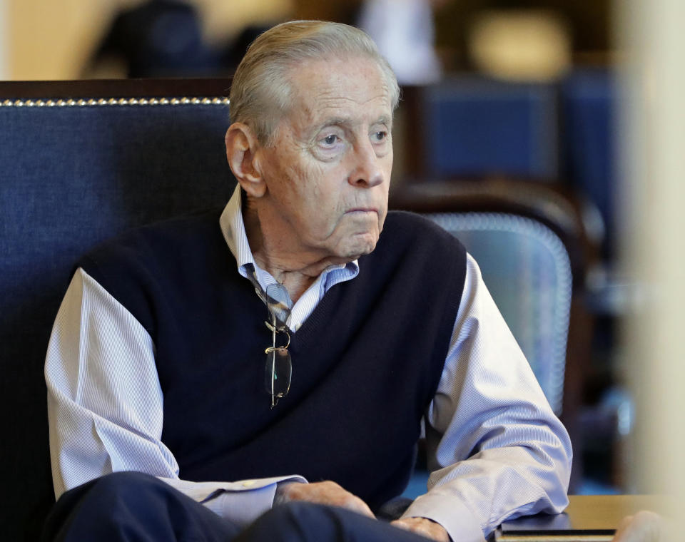 FILE - This Feb. 7, 2019 file photo, Fred Wilpon, majority owner of the New York Mets, speaks with a friend in a hotel lobby during baseball owners meetings in Orlando, Fla. Before New York real estate developer Wilpon would become part-owner and then sole owner of the New York Mets for over 30 years, he was a 17-year-old first generation college student who had gotten off an airplane for the first time in his life to attend the University of Michigan. (AP Photo/John Raoux, File)