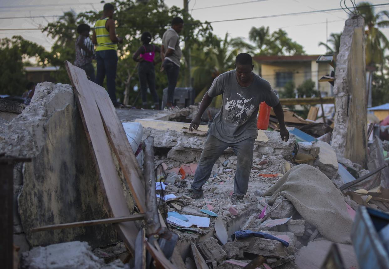 A man tries to recover belongings from his home destroyed by the earthquake in Les Cayes, Haiti, Saturday, Aug. 14, 2021. A 7.2 magnitude earthquake struck Haiti on Saturday, with the epicenter about 125 kilometers (78 miles) west of the capital of Port-au-Prince, the U.S. Geological Survey said.