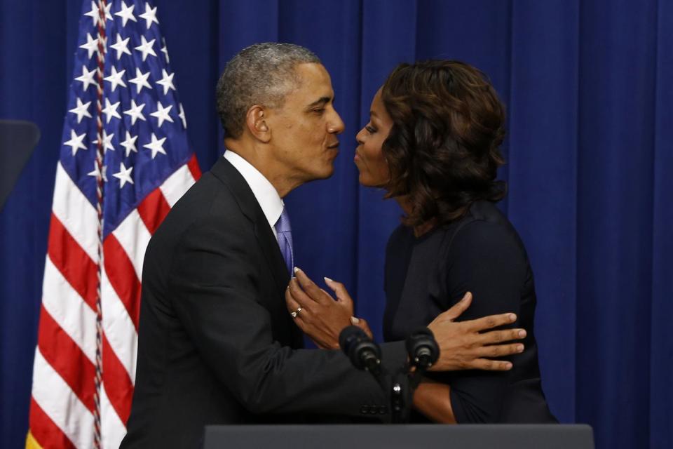 President Barack Obama leans over to kiss first lady Michelle Obama after she introduced him after speaking about college education, Thursday, Jan. 16, 2014, in the Eisenhower Executive Office Building on the White House complex in Washington. The event which is to promote opportunities for students to attend and finish college and university, was attended by college and university presidents and leaders from nonprofits, foundations, governments and businesses. (AP Photo/Charles Dharapak)