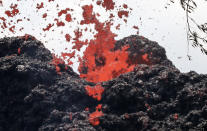 <p>A lava fissure erupts in the aftermath of eruptions from the Kilauea volcano on Hawaii’s Big Island, on May 12, 2018 in Pahoa, Hawaii. (Photo: Mario Tama/Getty Images) </p>