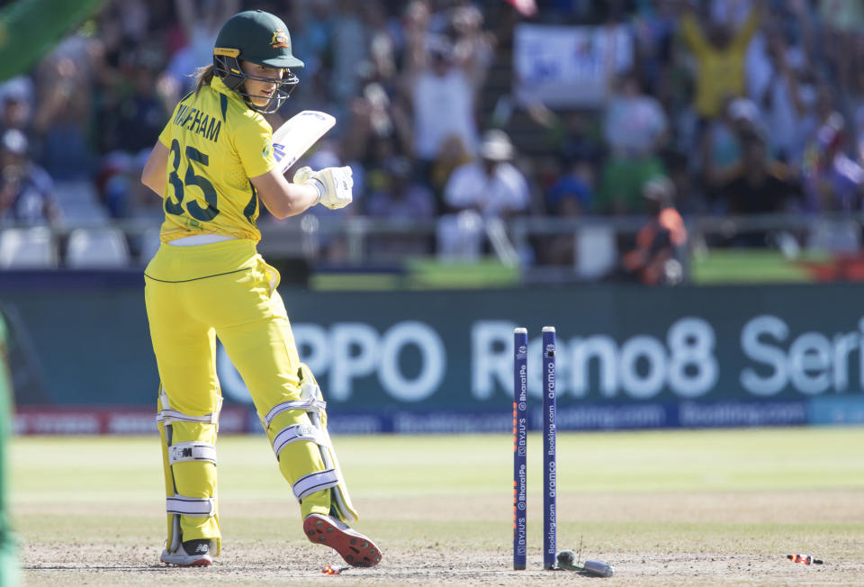 Australia's Georgia Wareham is bowled out against South Africa during the Women's T20 World Cup semifinal cricket match in Cape Town, South Africa, Sunday Feb. 26, 2023. (AP Photo/Halden Krog)