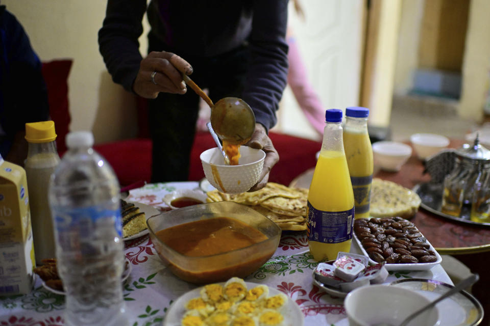 A man who has been displaced by the earthquake prepare Iftar to break his Ramadan fast with his family, in Amizmiz, near Marrakech, Thursday, April 4, 2024. (AP Photo)