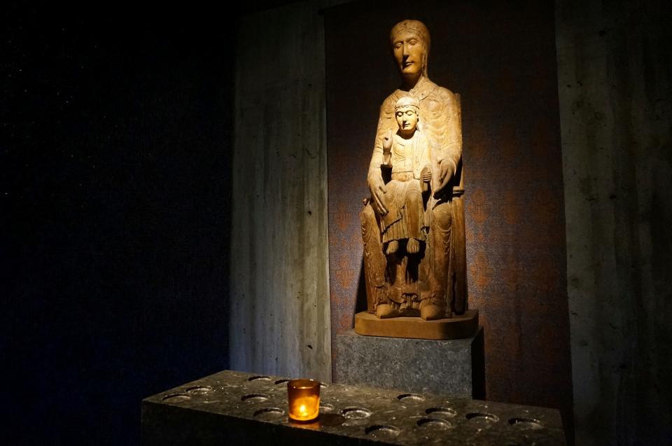 A 12th-century French statue of the Virgin Mary and the child Jesus reflects candlelight in a small chapel inside the campus church of Saint John's University in Collegeville, Minn., on Tuesday, Nov. 8, 2022. The university, founded by Benedictine monks whose monastery stands next to the church, and its twin institution for women, the College of Saint Benedict, have made efforts to welcome and affirm LGBTQ students, a fraught concern for faith-based schools across the country. (AP Photo/Giovanna Dell'Orto)