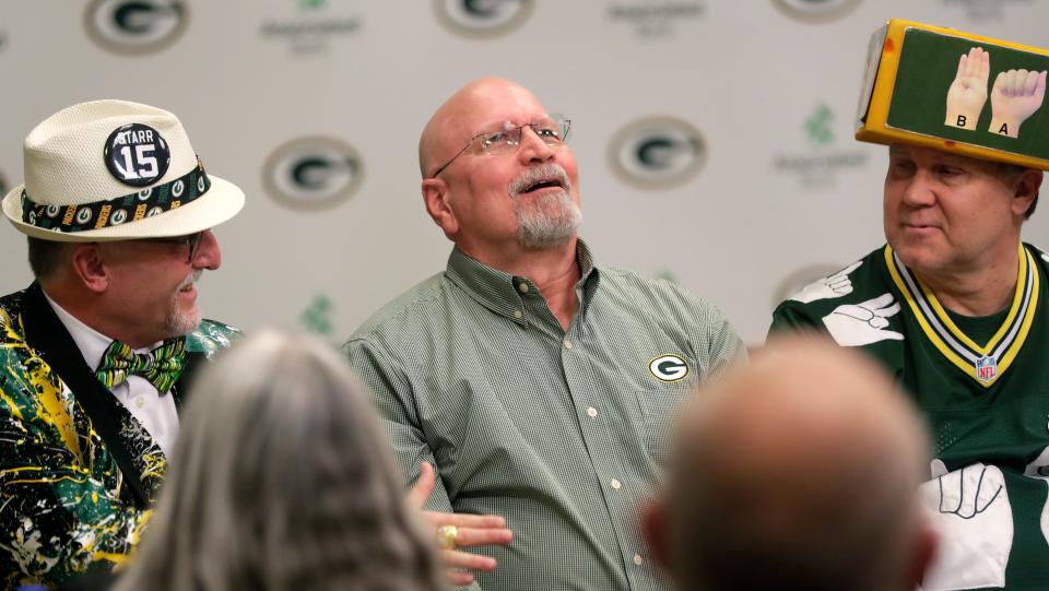 Dan “Bogie” Bogenschuetz, middle, of Sheboygan reacts after being named the 26th member of the Green Bay Packers FAN Hall of Fame during the ceremony Monday at Lambeau Field in Green Bay.