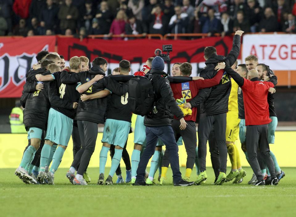 Austria's team celebrates winning the match at the Euro 2020 group G qualifying soccer match between Austria and North Macedonia at Ernst-Happel stadium in Vienna, Austria, Saturday, Nov. 16, 2019. (AP Photo/Ronald Zak)