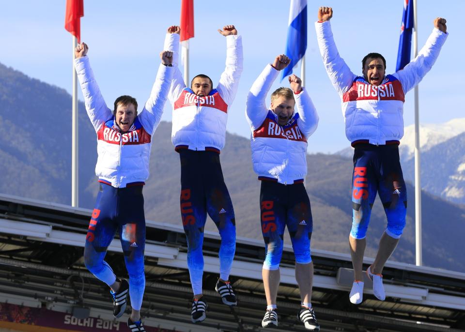 Russia-1 four-man bobsleigh, pilot Alexander Zubkov, pushman Alexey Negodaylo, pushman Dmitry Trunenkov and brakeman Alexey Voevoda celebrate at the Bobsleigh Four-man Medal Ceremony at the Sanki Sliding Center during the Sochi Winter Olympics on February 23, 2014.      AFP PHOTO / ALEXANDER KLEIN        (Photo credit should read ALEXANDER KLEIN/AFP/Getty Images)