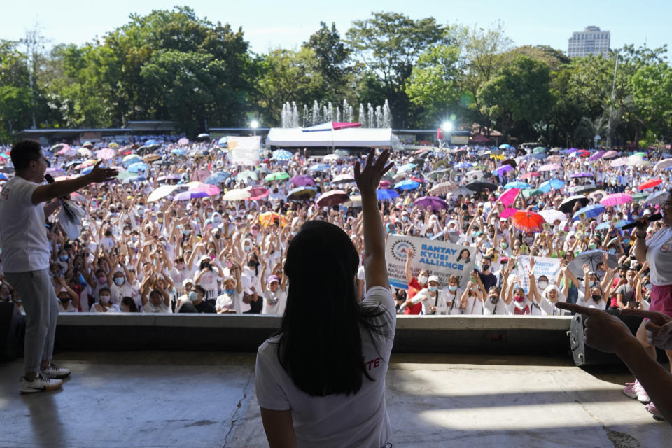 Quezon City Mayor Joy Belmonte, center, greets the crowd as she starts her re-election campaign in Quezon City, Philippines on Friday, March 25, 2022. Candidates for thousands of provincial, town and congressional posts started campaigning across the Philippines Friday under tight police watch due to a history of violent rivalries and to enforce a lingering pandemic ban on handshakes, hugging and tightly packed crowds that are a hallmark of often circus-like campaigns. (AP Photo/Aaron Favila)