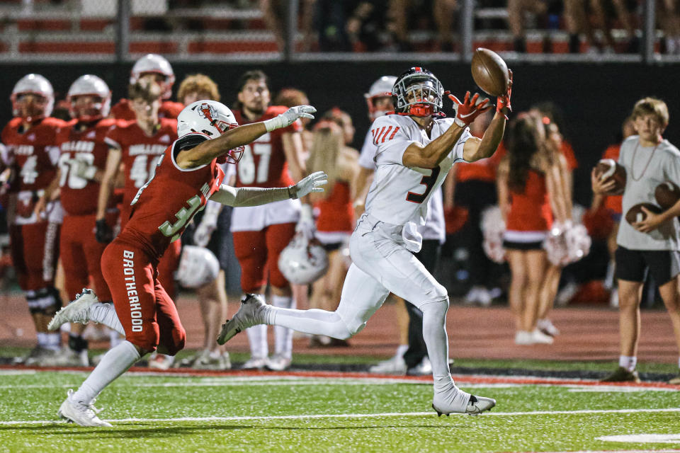 Mustang's Jacobe Johnson (3) catches a pass and runs for a touchdown in the third quarter against Yukon on Friday.