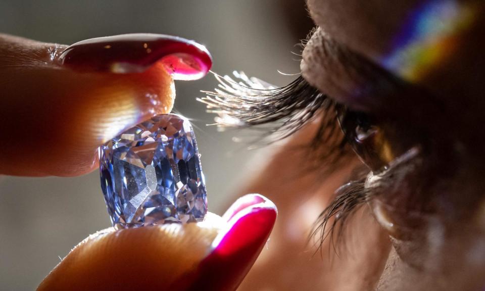 <span>A model holds a De Beers diamond. The company was once responsible for 85% of the world’s mined diamonds.</span><span>Photograph: Fabrice Coffrini/AFP/Getty Images</span>