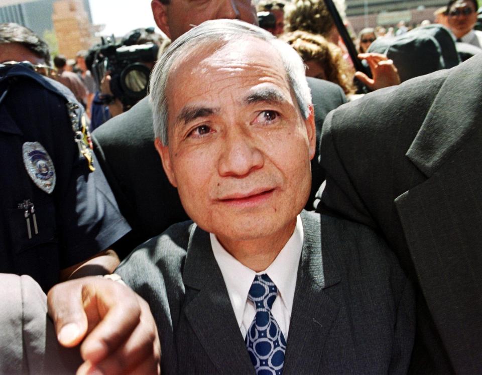 Former Los Alamos nuclear scientist Wen Ho Lee (C) is escorted back into the Federal Courthouse after addresses the media following his release from nine months of solitary confinement, Sept. 13, 2000, in Albuquerque, New Mexico.  (Photo: Mike Fiala/AFP/Getty Images)