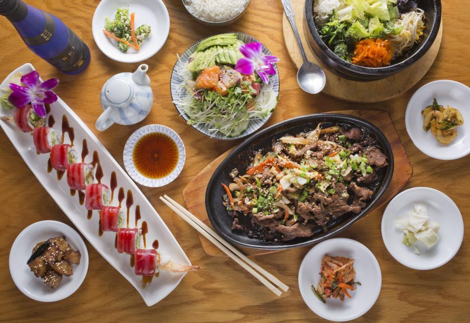 The bulgogi entree with banchan, sushi roll, poke appetizer, veggie dolsot bibimbap and a beer at Japanese Oriental Restaurant on North High Street.