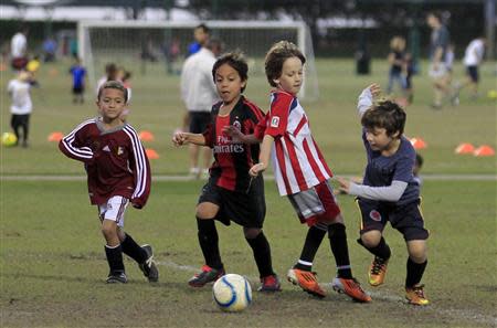 Young soccer team members take part in a practice at a publicly-funded field in Weston, Florida November 14, 2013. REUTERS/Joe Skipper