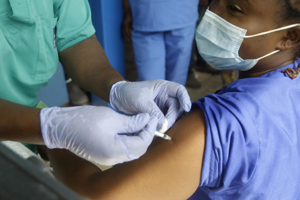 FILE - In this March 12, 2021, file photo, a hospital worker receives one of the country's first coronavirus vaccinations, using the AstraZeneca vaccine manufactured by the Serum Institute of India and provided through the global COVAX initiative, at Yaba Mainland hospital in Lagos, Nigeria. In the global race to vaccinate people against COVID-19, Africa is tragically at the back of the pack. In Nigeria, Africa's biggest country with more than 200 million people, only 0.1% are fully protected. (AP Photo/Sunday Alamba, File)