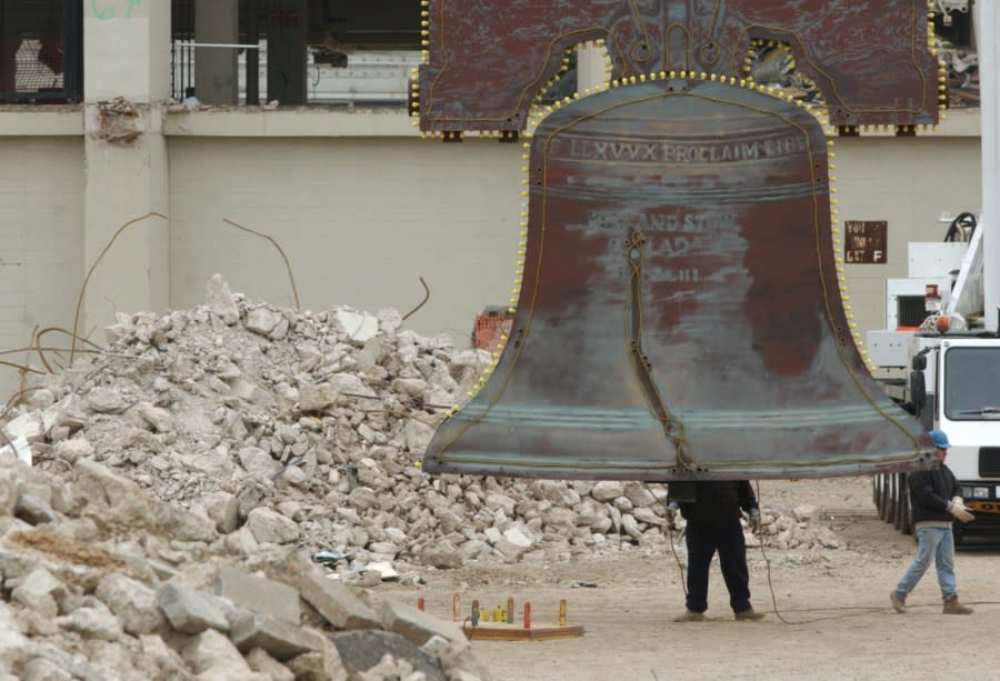 Riggers examine Veterans Stadium’s “Liberty Bell” after is was removed from the stadium in Philadelphia, Thursday, Feb. 19, 2004. The bell will be placed in storage until a decision is made about what to do with it, the team said. Veterans Stadium, home of the Philadelphia Phillies since 1971, is slated for demolition in the spring. (AP Photo/Jacqueline Larma)